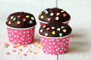 Tre muffin al cioccolato con zuccherini a forma di cuore