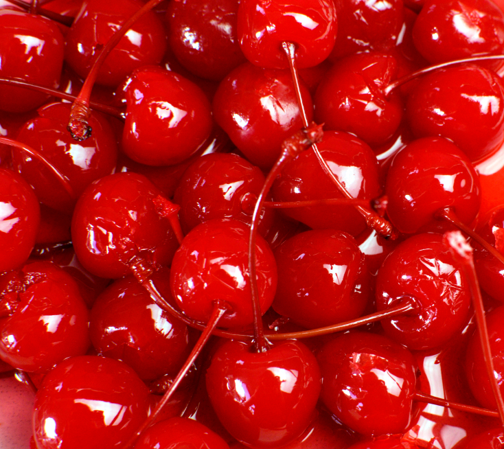 Festive background of red cocktail maraschino cherries with stems