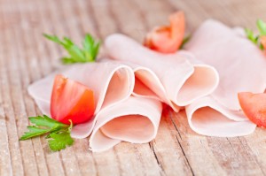 slices of ham with parsley and tomato