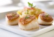 Seared sea scallops with orzo and vegetables.