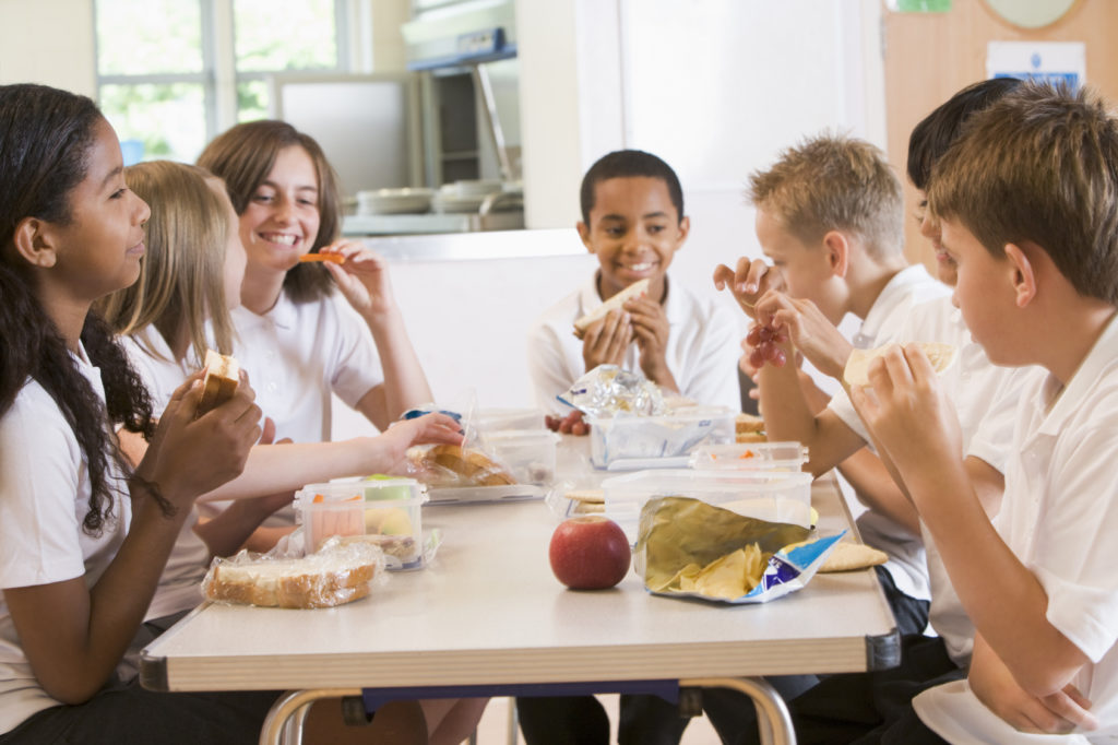 Schoolchildren enjoying their lunch in a school cafeteria