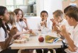 Schoolchildren enjoying their lunch in a school cafeteria