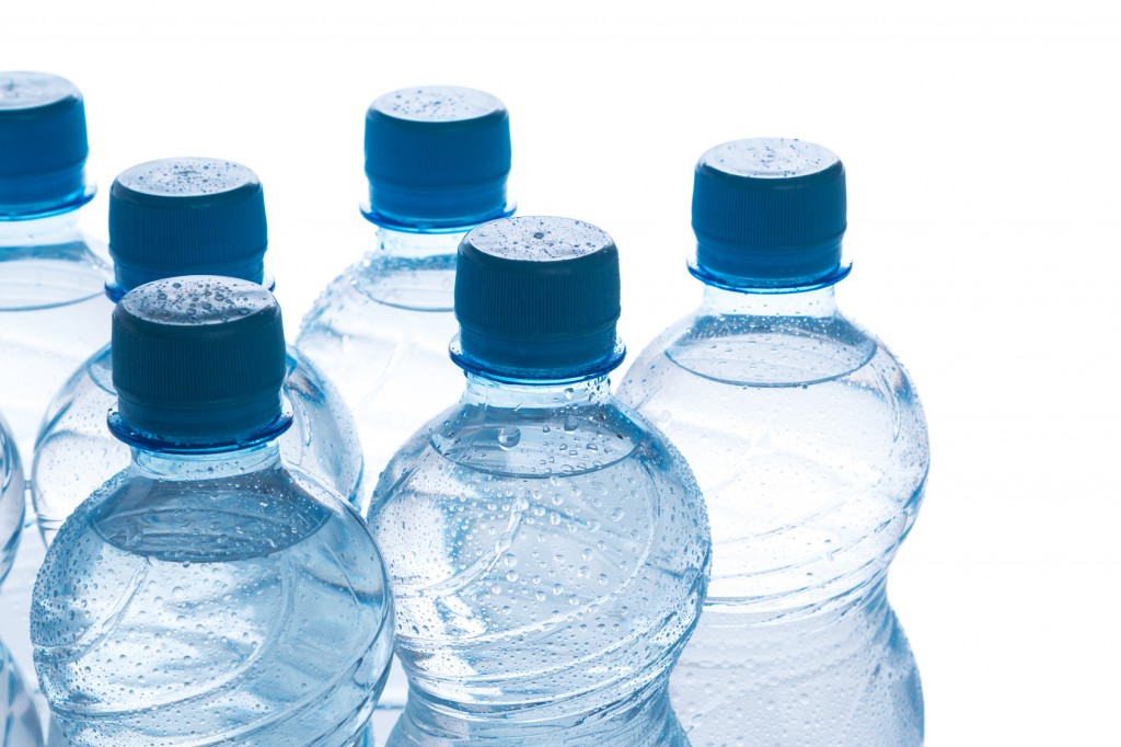 Bottles with water on white background