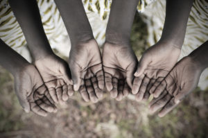 Crisi alimentare African Children Holding Hands Cupped To Beg Help. Poor African children keeping their cupped hands, asking for help. African children suffer from poverty, diseases, water scarcity and malnutrition.