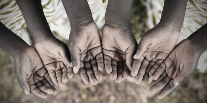 African Children Holding Hands Cupped To Beg Help. Poor African children keeping their cupped hands, asking for help. African children suffer from poverty, diseases, water scarcity and malnutrition.
