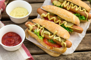 Wurstel Hot dog in a bun with mustard and vegetables