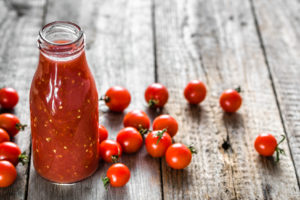 Bottle of tomato juice and fresh tomatoes, organic healthy food concept