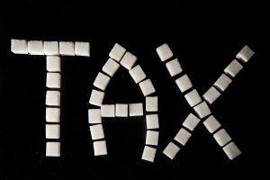 Zollette di zucchero formano la parola tax; concept: sugar tax