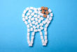 Sugar destroys the tooth enamel and leads to tooth decay. Sugar cubes are laid out in the form of a tooth and brown sugar symbolizes caries.