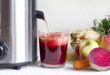 Juicer and juice with fresh fruits and vegetables