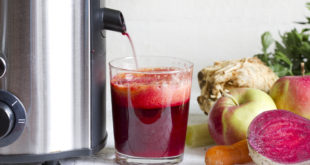 Juicer and juice with fresh fruits and vegetables