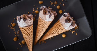 Three frozen ice cream desserts in sugar cones