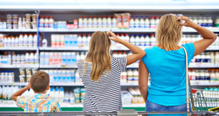 Family chooses dairy products in shop