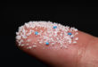 Micro plastic.Small Plastic pellets on the finger. microplastiche frammenti plastica