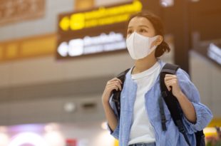Asian travelers girl with medical face mask to protection the coronavirus in airport