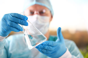 Acqua, Male scientist hold in arm empty vials closeup