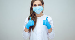 woman doctor wearing medical mask doing thumb up.
