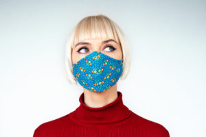 Pensive, thoughtful woman wearing protection handmade face mask during the quarantine of coronavirus infection outbreak. Copy, empty space for text mascherine