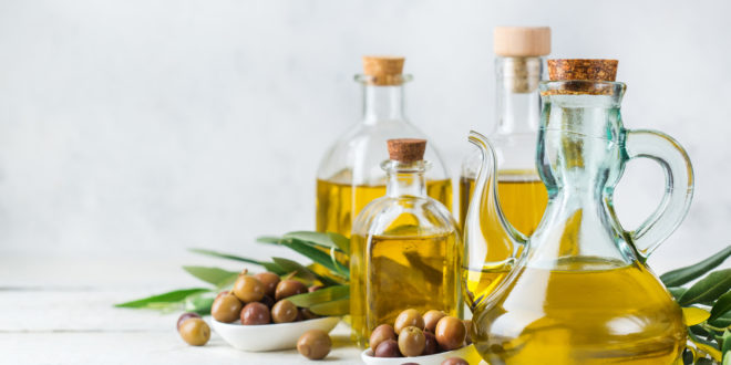 Assortment of fresh organic extra virgin olive oil in bottles