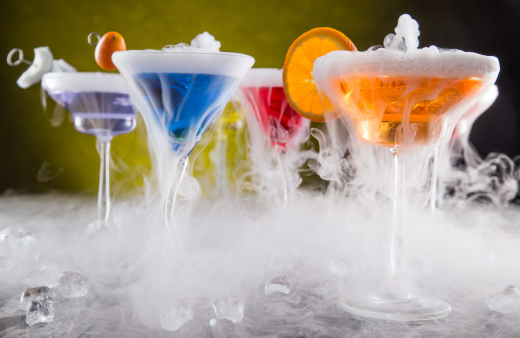 Cocktails with ice vapor on bar desk