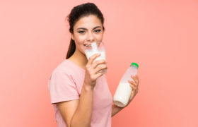 Ragazza dell'adolescente che beve latte della prima colazione