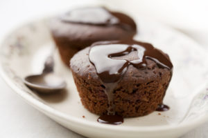 Due tortini, cupcake o brownie con glassa al cioccolato su un piatto