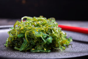 Insalata di alghe goma wakame su un piatto in un ristorante giapponese o asiatico