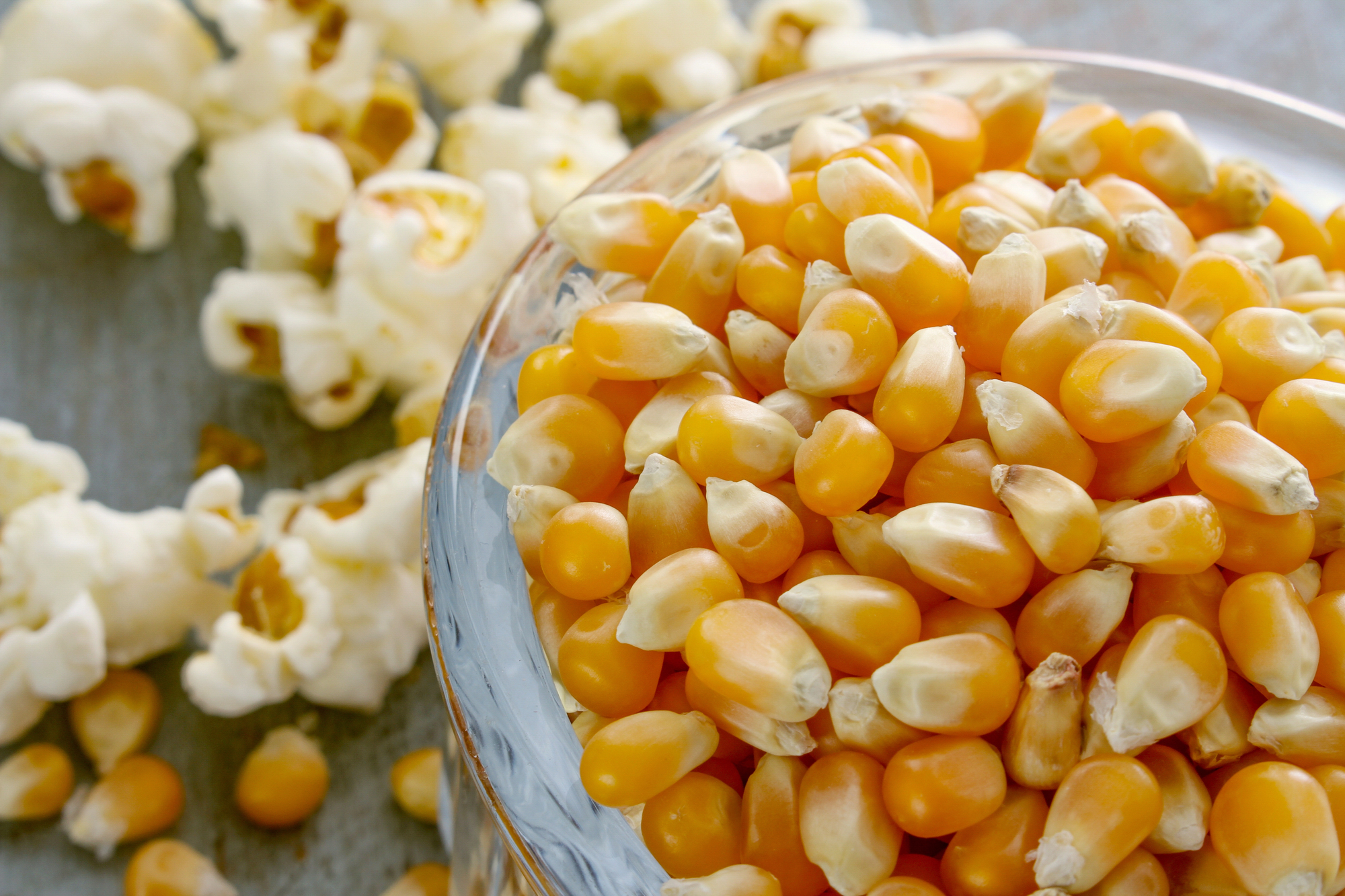 Ciotola di mais per popcorn, con popcorn sullo sfondo